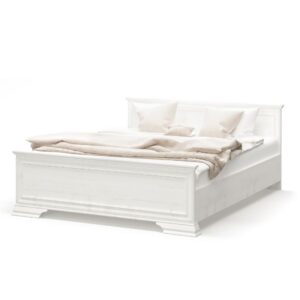 White wooden bed with beige linens and pillows, set against a plain background as a ready-made bed setup.