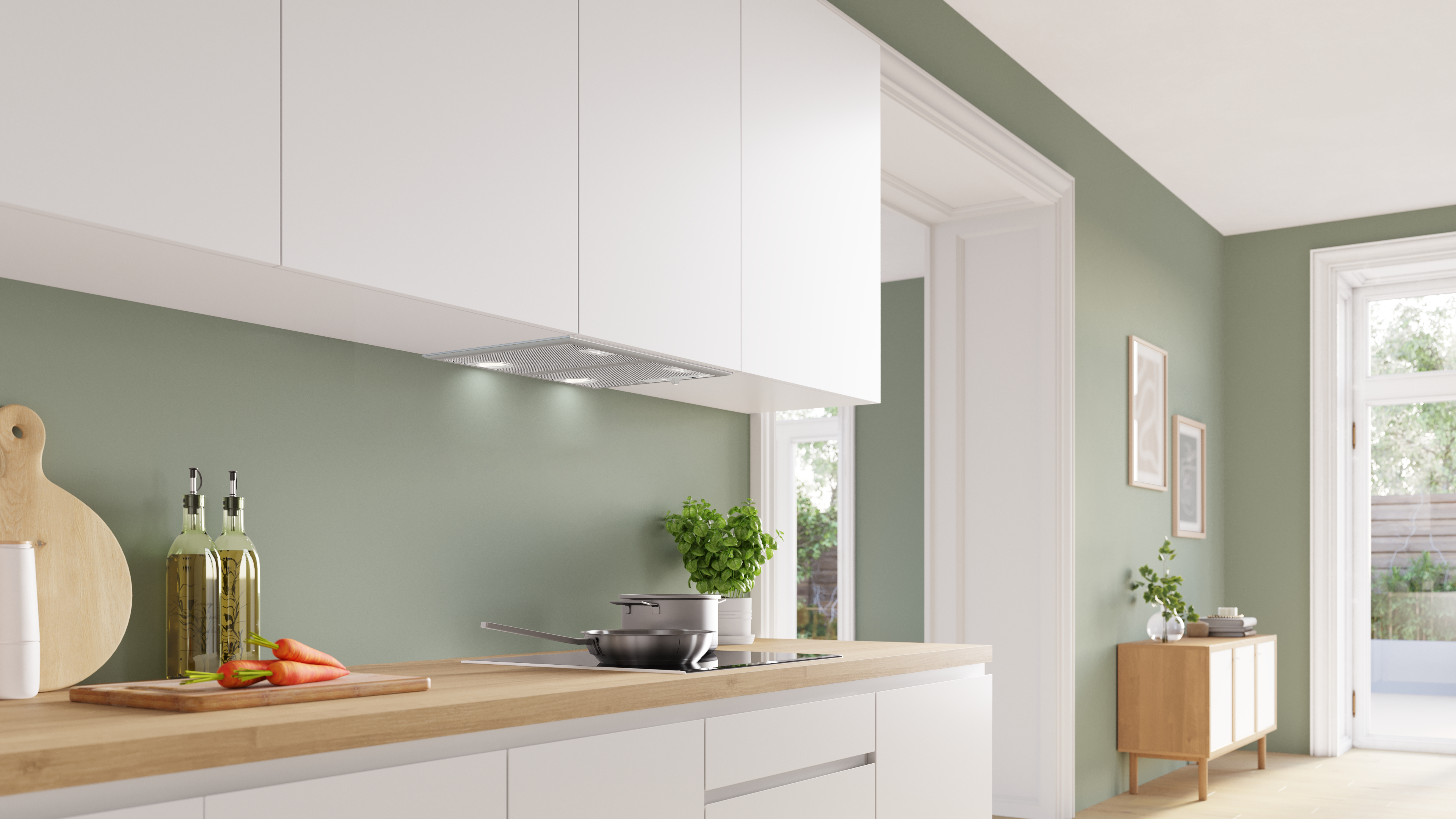 Modern kitchen with white upper cabinets green walls and a wooden island a pan on the stove and carrots on a cutting board Globalmtc
